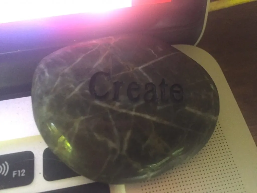 Writing Rituals - "Create" stone LeAura uses as a reminder to stay on track to create content rather than consume distractions. #Create #WritingRituals #Talisman #Creativity #iCreateDaily